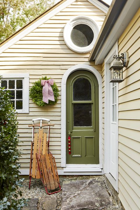 an entryway decorated with antique sleds