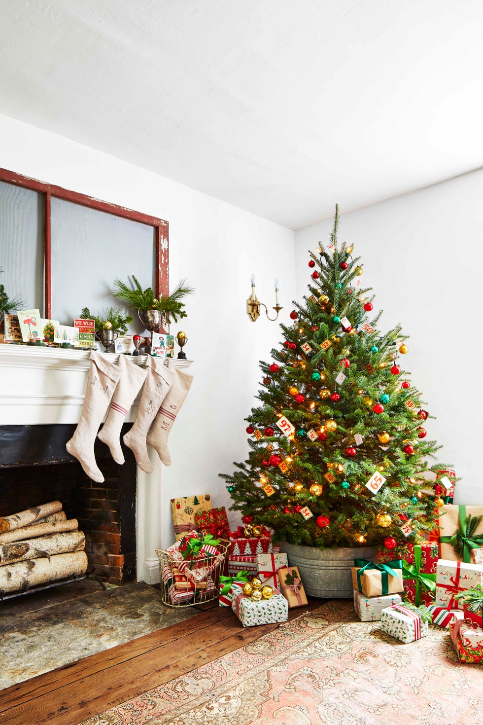 decorated christmas tree in galvanized bucket in white farmhouse living room