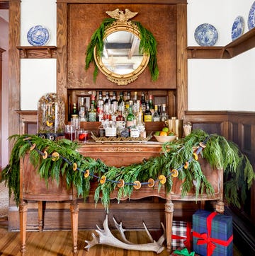 a garland of greenery decorated with dried citrus strung on a ribbon