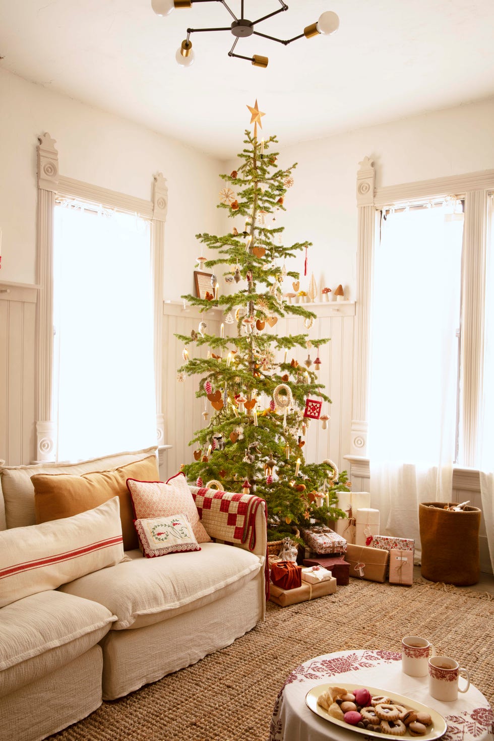 sparse swedish inspired rustic christmas tree in an airy white living room