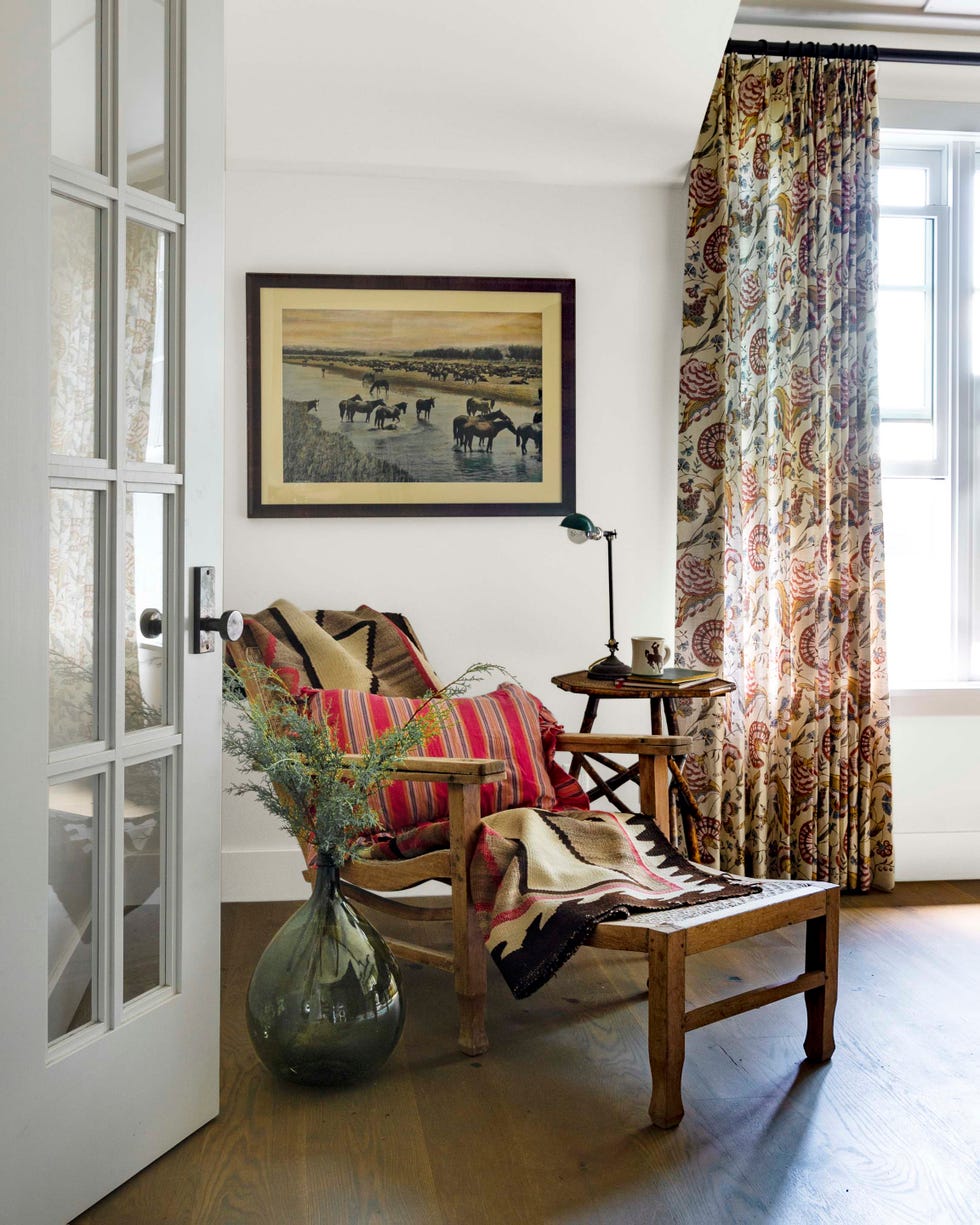 a reading nook with vintage blankets in a wyoming log cabin