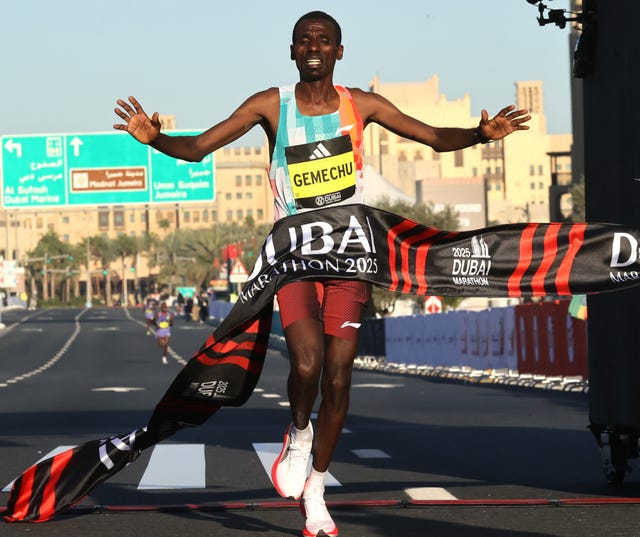 runner crossing the finish line at the dubai marathon