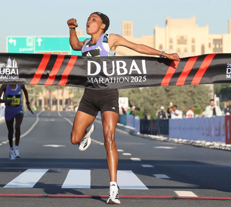 athlete crossing the finish line at the dubai marathon 2025
