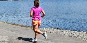 woman running along water