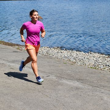 a person stretching on a path while on a run