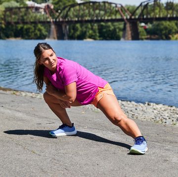 a runner stretching How to Improve Your Running Recovery Plan