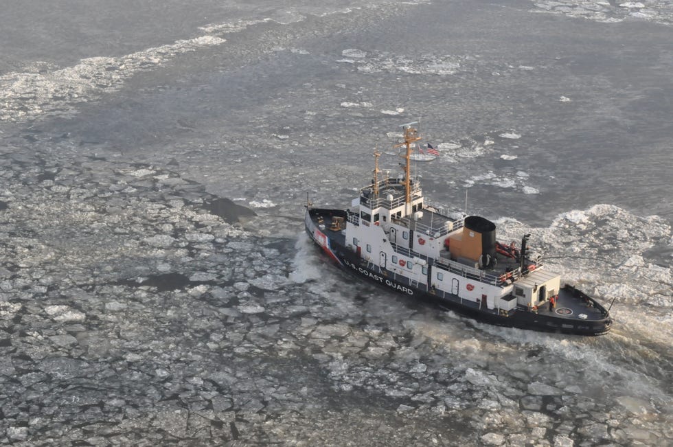 us coast guard tugboat navigating through icy waters