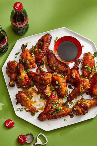 cola glazed chicken wings with sauce on a white platter