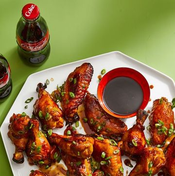 cola glazed chicken wings with sauce on a white platter