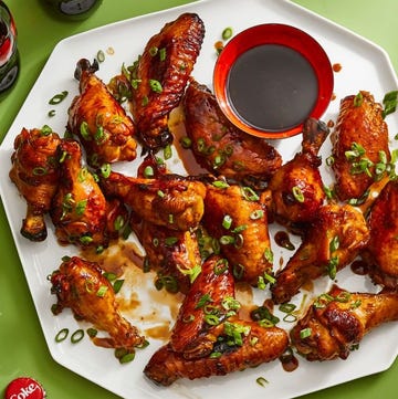 cola glazed chicken wings with sauce on a white platter