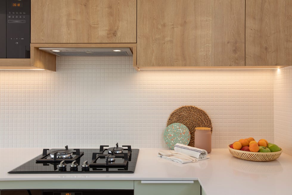 cocina de color verde empolvado con armarios superiores de madera