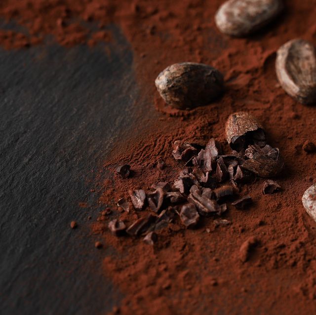 cocoa beans and cocoa powder on dark background