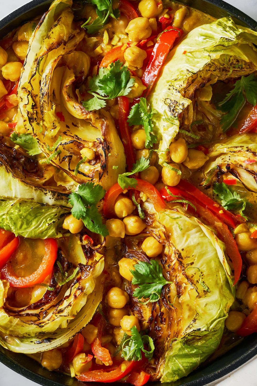 coconut braised cabbage with peppers and chickpeas in a skillet
