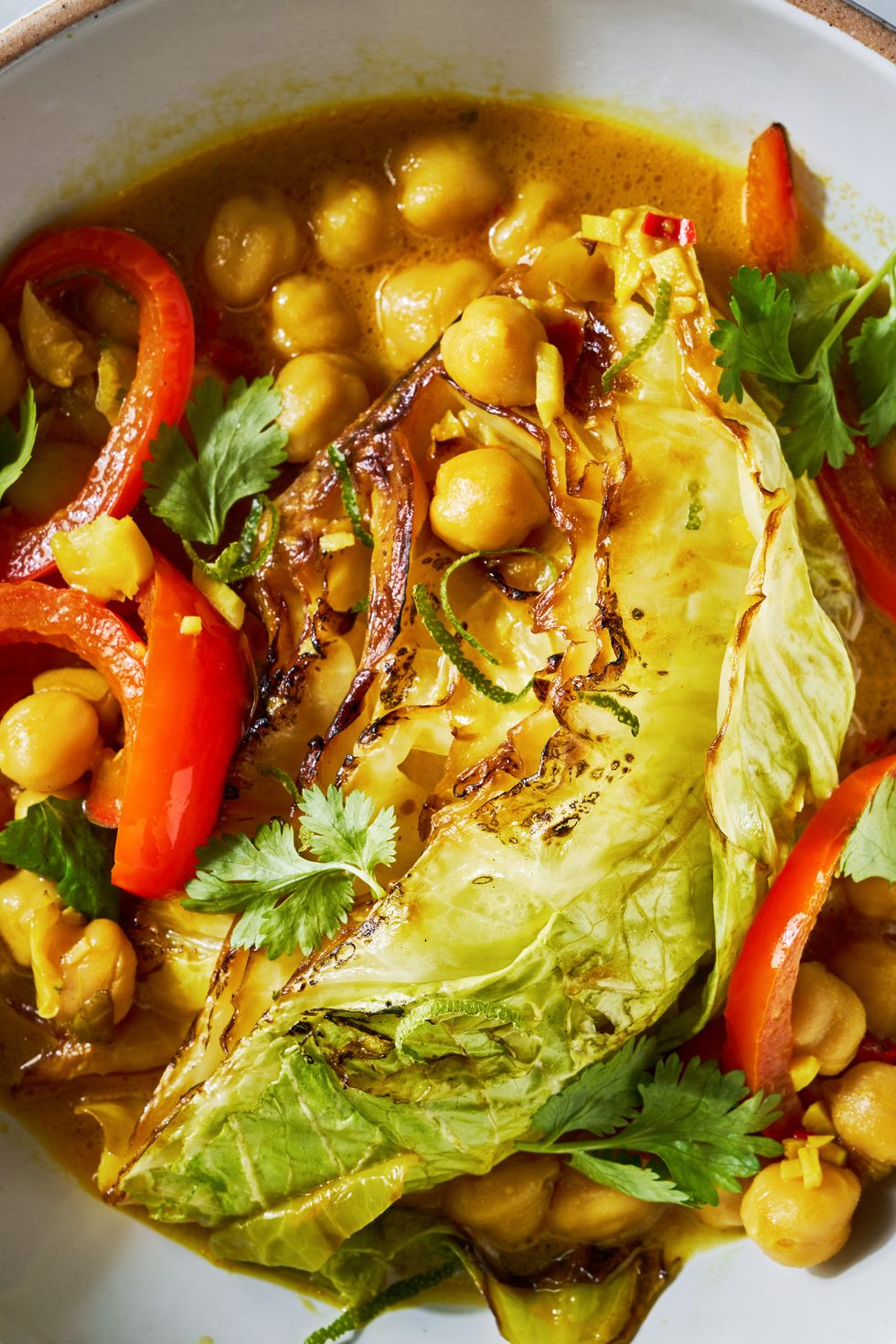 coconut braised cabbage with peppers and chickpeas in a skillet
