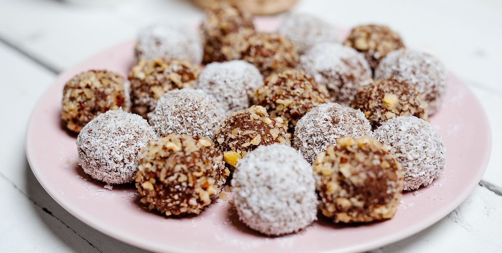 Coconut covered rum balls on a plate