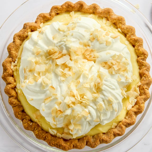 coconut cream pie topped with whipped cream and toasted coconut flakes