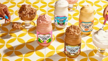 various jars of coconut cult yogurt displayed with servings in bowls