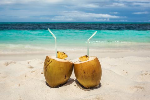 coconut drinks on beach in maldives, vacation in paradise, sunny day in topical island