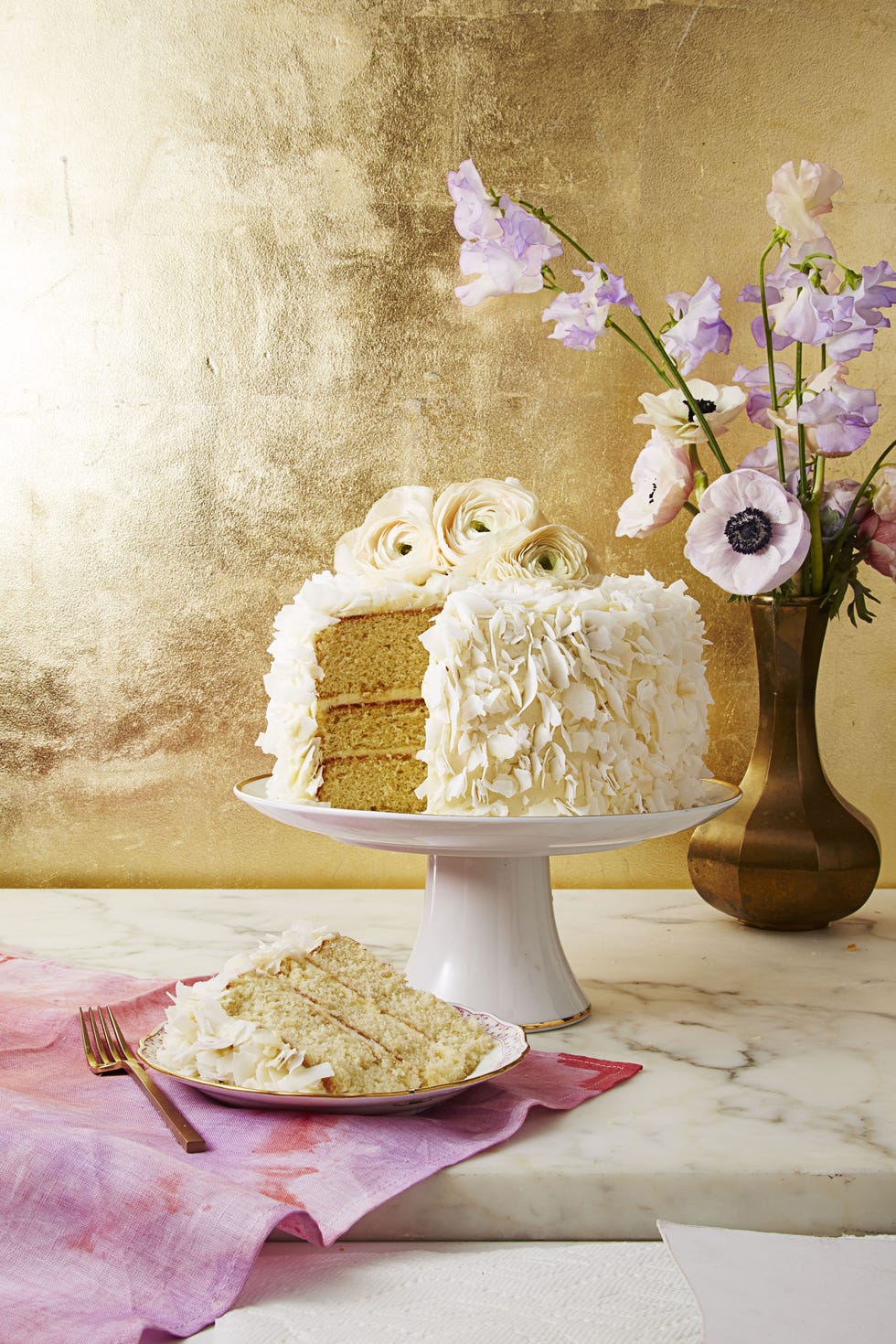 a white coconut layer mothers day cake with coconut shavings on top