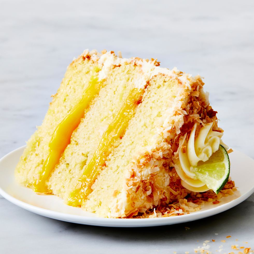 a layered coconut cake filled with lime curd and covered with toasted coconut