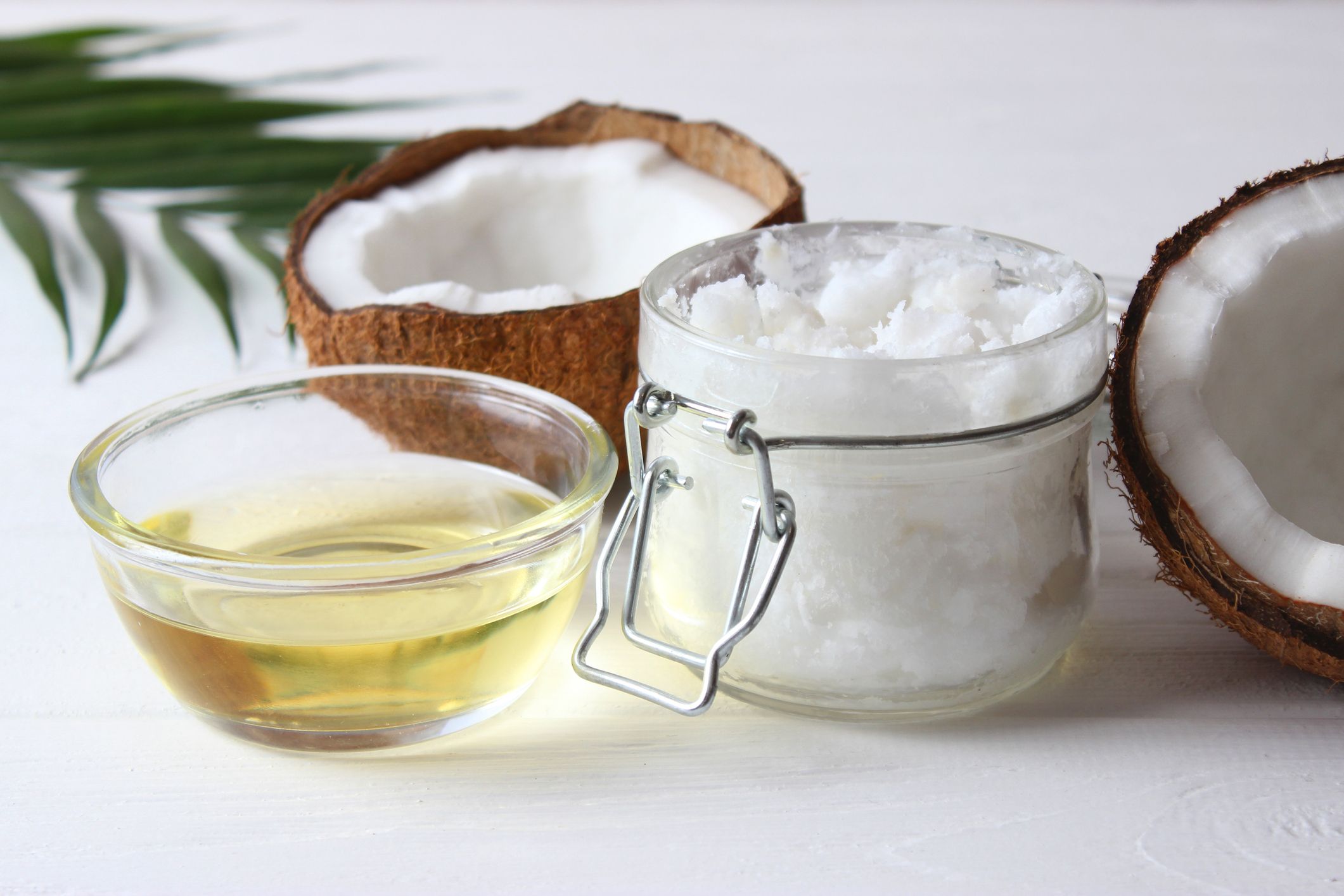 coconut oil and coconuts, palm branches close up