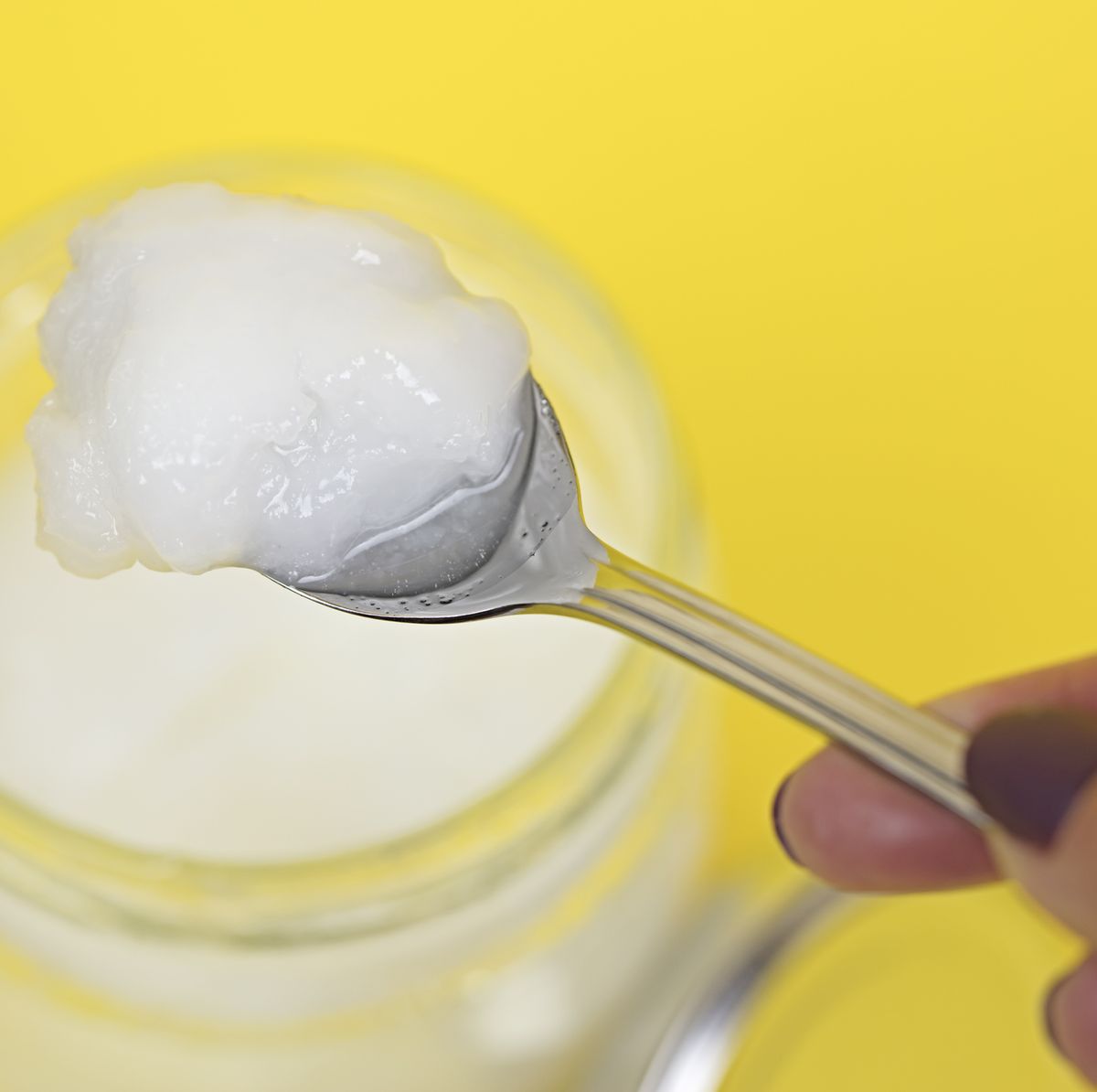 Coconut oil in jar with spoon