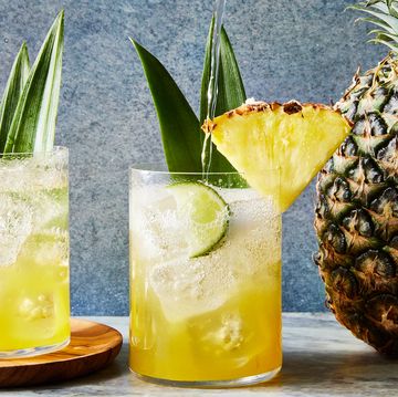 coconut pineapple spritz with a pineapple wedge and pineapple leaf garnish