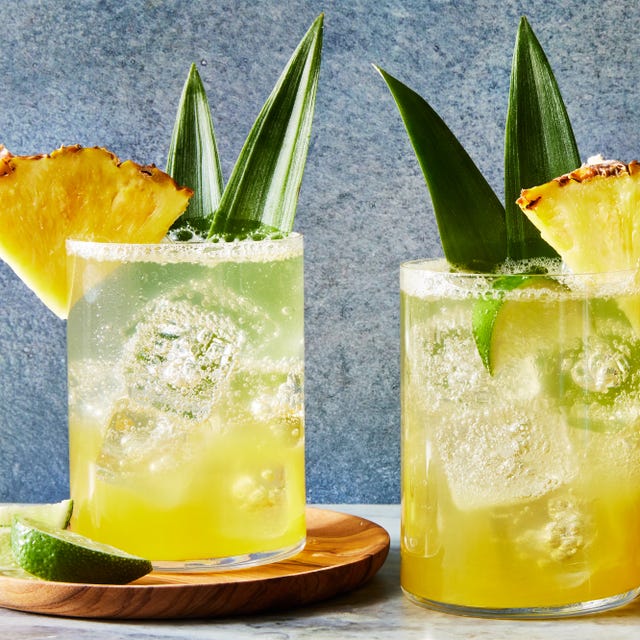 Coconut-Pineapple Spritz coconut pineapple spritz with a pineapple wedge and pineapple leaf garnish