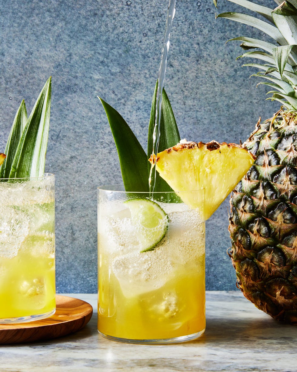coconut pineapple spritz with a pineapple wedge and pineapple leaf garnish
