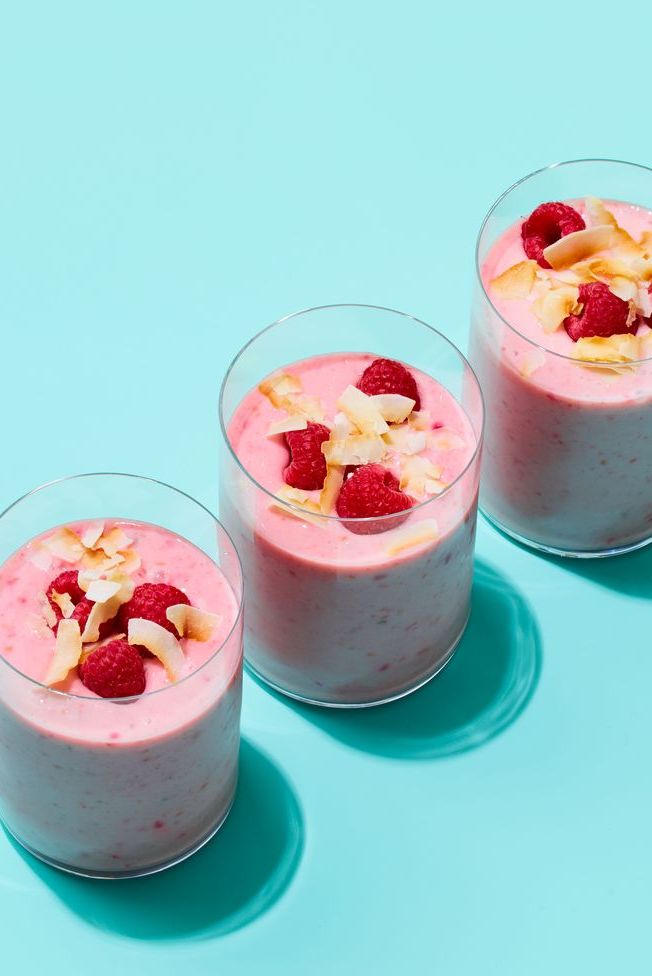 three glasses of creamy, pink coconut raspberry smoothie