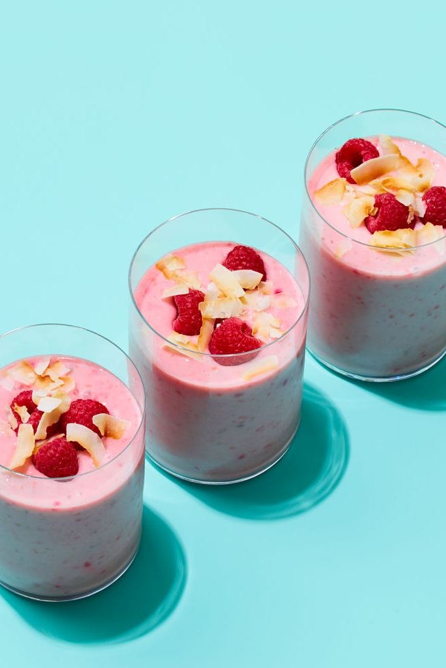 three glasses of creamy, pink coconut raspberry smoothie