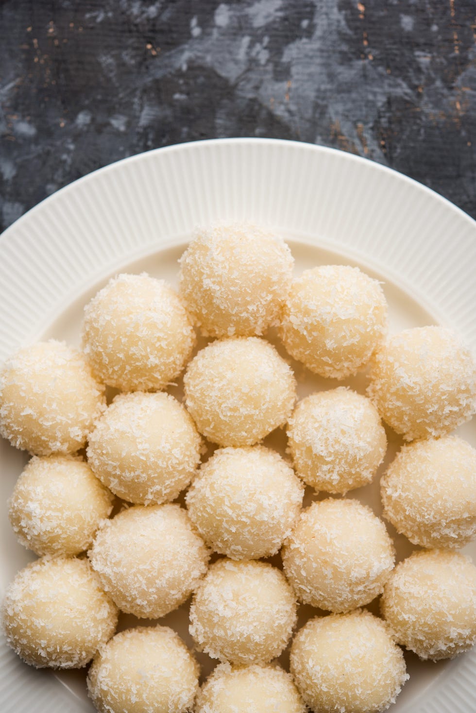 Coconut Sweet Laddoo OR Nariyal Ladduis a Popular Festival food from India. Served over moody background, selective focus