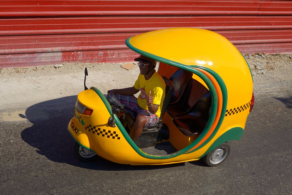lemon yellow coco motor bike auto rickshaw taxi in old havana cuba