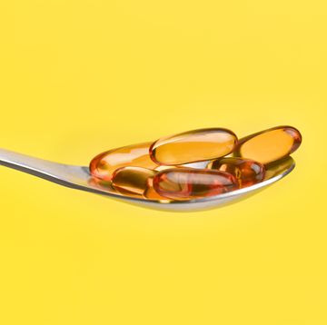 cod liver oil capsules on spoon