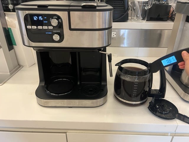 cuisinart coffee maker shown with a thermometer taking the temperature of a full pot of coffee