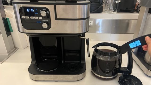 cuisinart coffee maker shown with a thermometer taking the temperature of a full pot of coffee