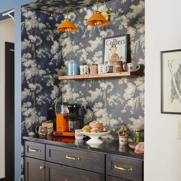 wisconsin summer cabin coffee bar with black painted cabinet in wallpapered alcove, open shelving above