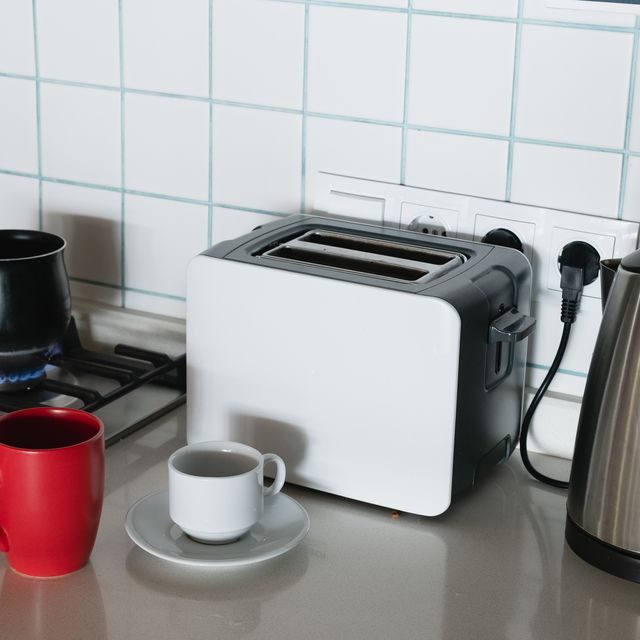 coffee is brewed in a turk on a gas stove, on fire. making coffee for breakfast. a turk for making turkish coffee, in the kitchen at home or in a hostel. there is a bright mug next to it. do it yourself. home life.