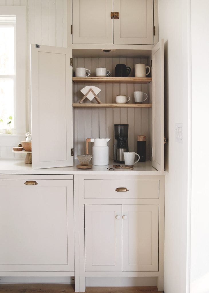 cabinet displaying coffee maker and accessories