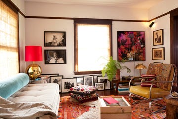 living room with red drum shade and floor cushions