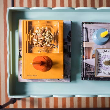 blue tray with books, nuts and candlesticks coffee table decor