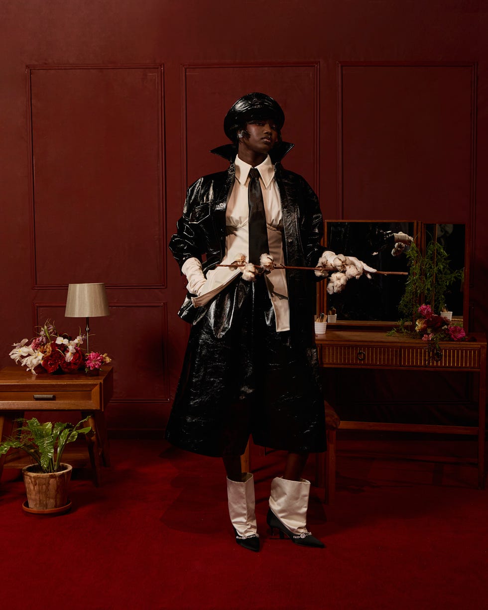 model wearing a dramatic outfit in a styled interior setting