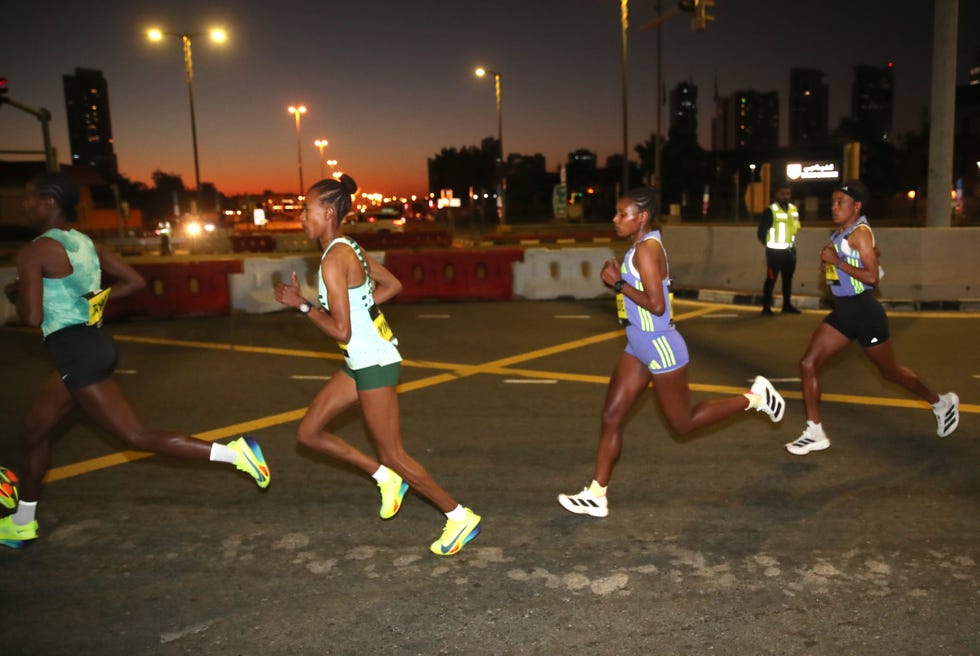 runners participating in a night race on a city street