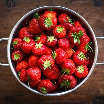 colander full of ripe strawberries