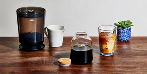 oxo cold brew coffee maker with glass of iced coffee
