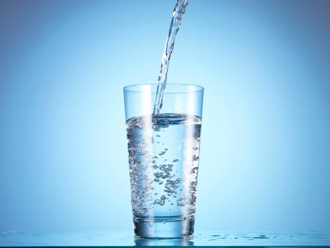 cold drink water being poured into glass