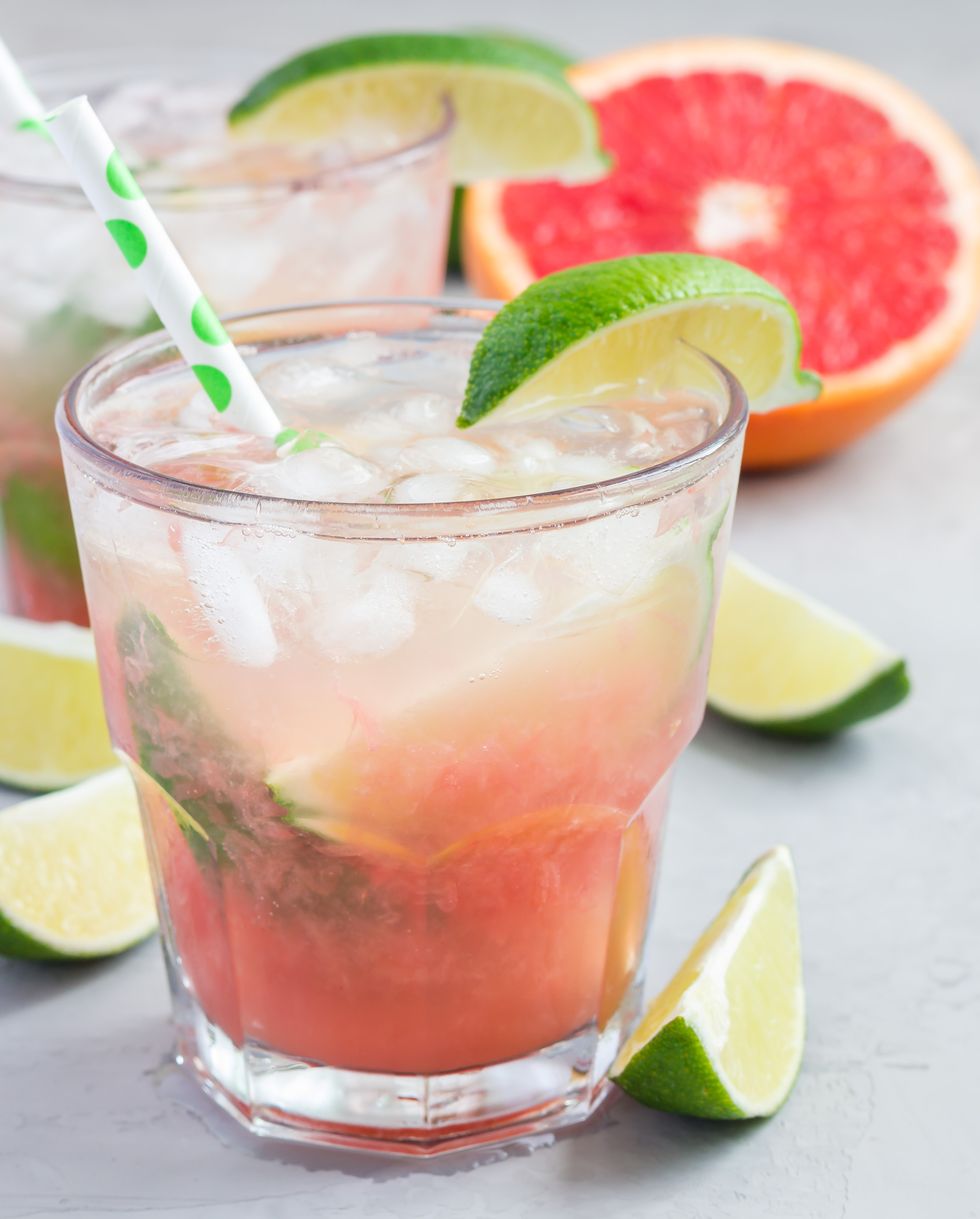 cold pink cocktail with fresh grapefruit, lime, copy space