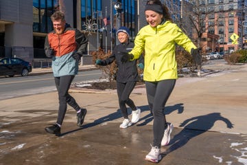 group of three individuals jogging outdoors in athletic clothing