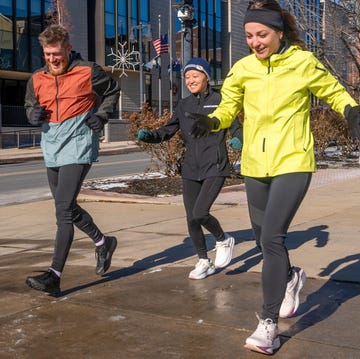Group of three individuals jogging outdoors in athletic clothing group of three individuals jogging outdoors in athletic clothing