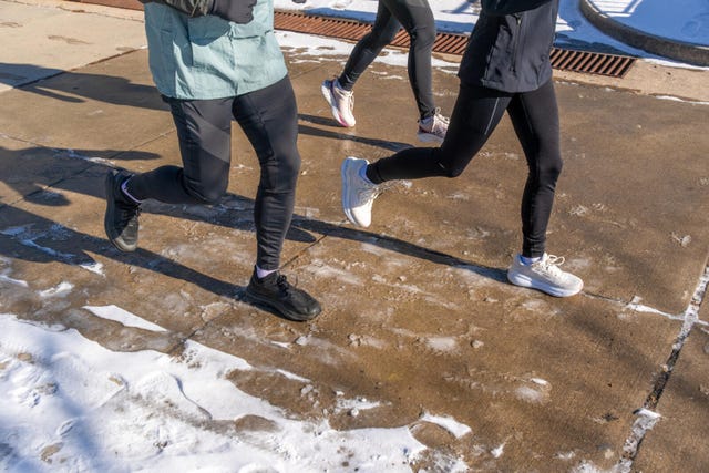 people jogging on a snowy path